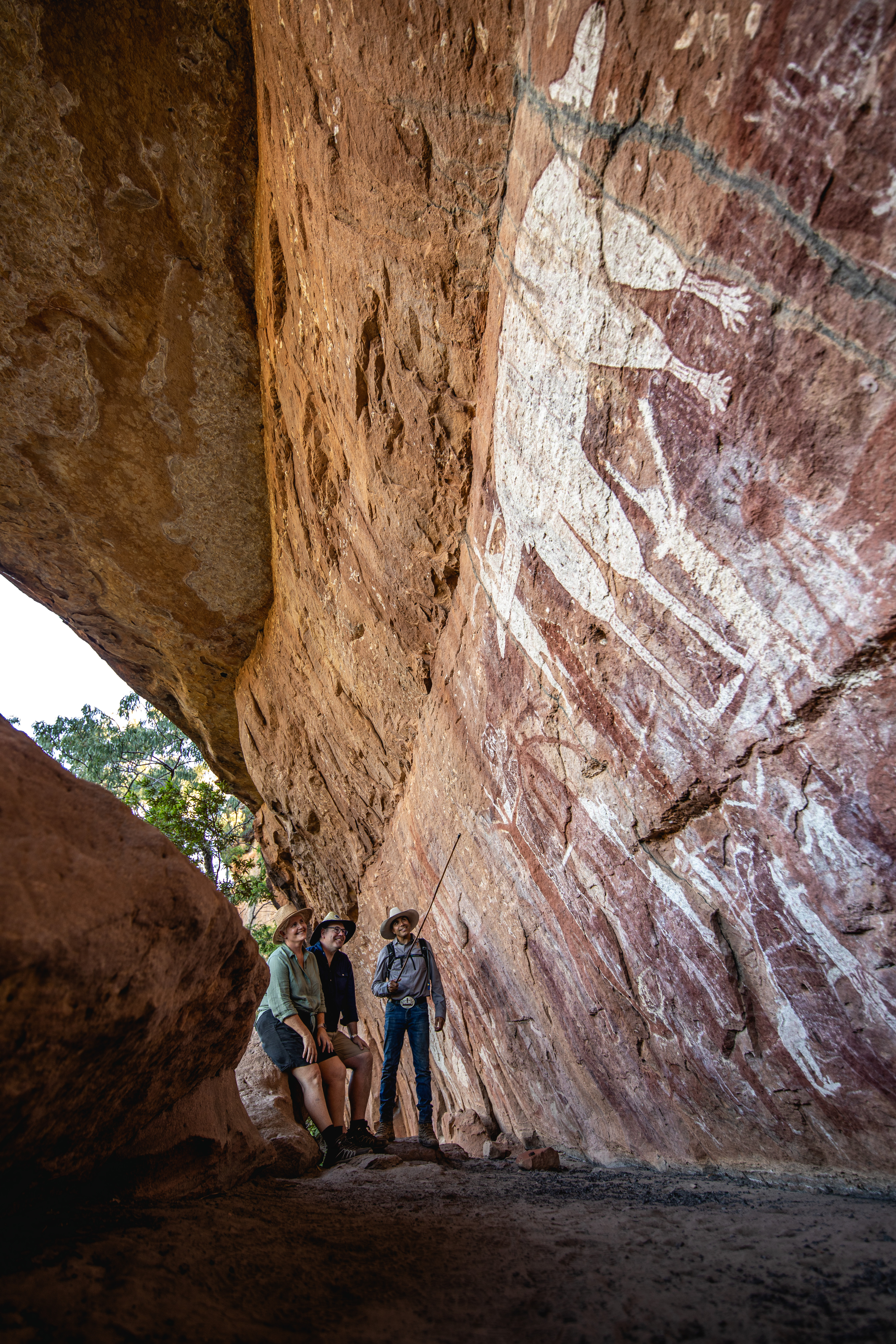 Johnny showing guests the ancient rock art at Magnificant Gallery